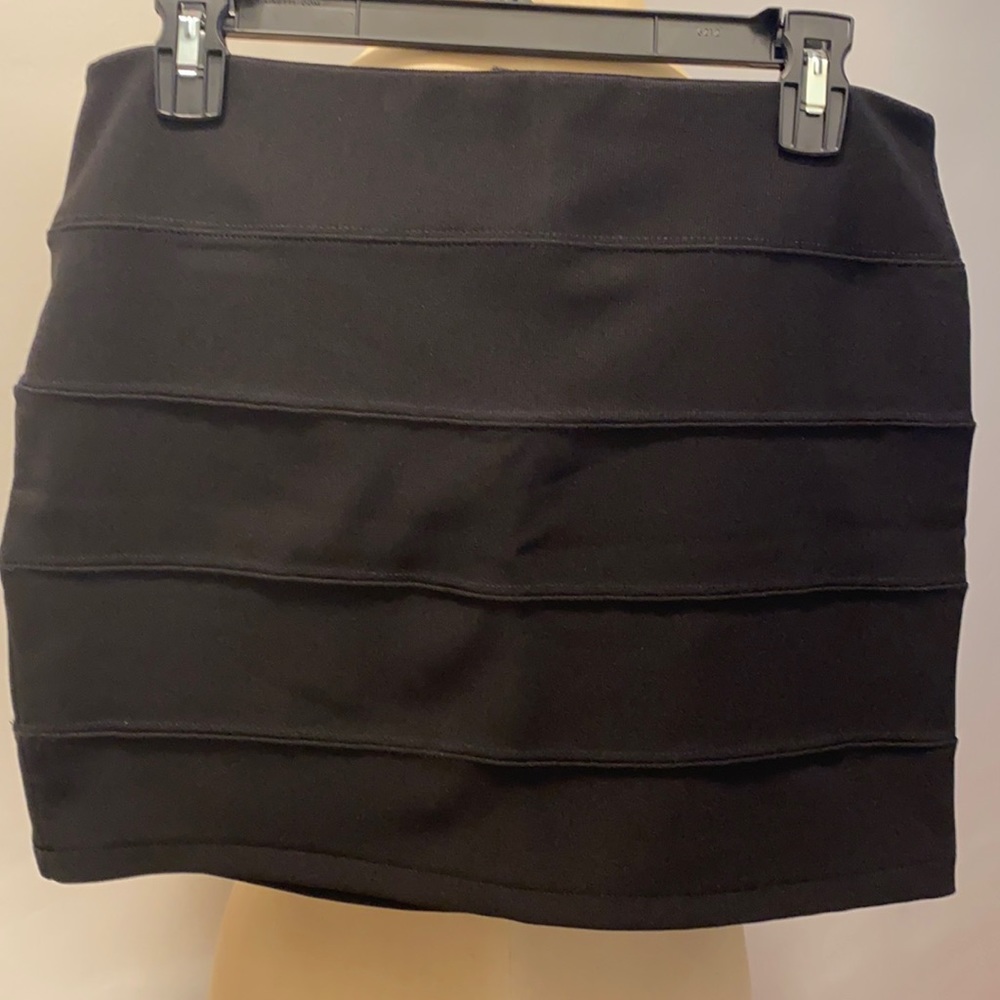 Black mini skirt 15” length. Zipper in back. This skirt doesn’t quit.